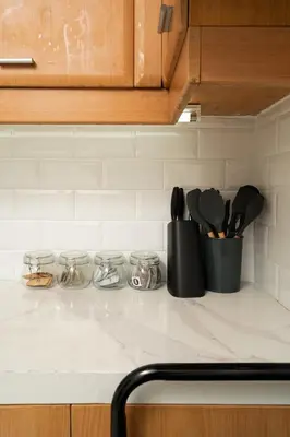 a kitchen counter with utensils on a counter top at Tranquil Greenbelt Makati Condo - Free Pool Access in Manila