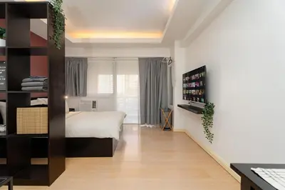 a bedroom with a bed and a book shelf at Tranquil Greenbelt Makati Condo - Free Pool Access in Manila