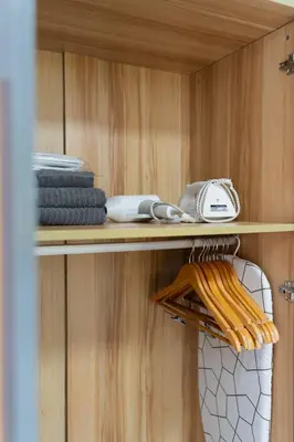 a shelf with towels and other items on it at Greenbelt Makati Condo with Balcony & Park Views in Manila