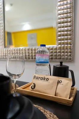 a bottle of water in a bag next to a glass at Greenbelt Makati Condo with Balcony & Park Views in Manila