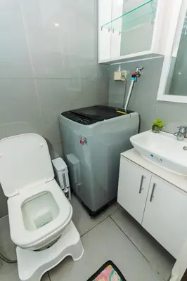 a small bathroom with a toilet and a sink at City Chill Spot Where Style Meets Smiles Swim Gym Park 1765 in Manila
