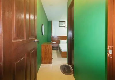 a hallway with a door and a room with green walls at Ranchotel General Trias Cavite by RedDoorz in Uldugan