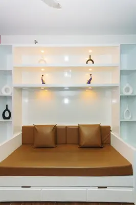 a couch in a room with shelves at Boutique Air Retreat Relax Laugh Swim Gym Car Park 1767 in Manila