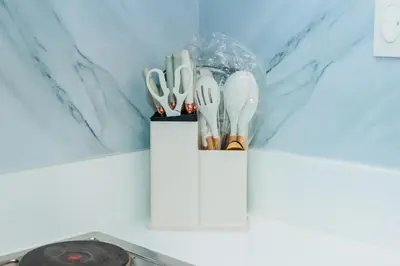 a white container with utensils in it on a counter at Boutique Air Retreat Relax Laugh Swim Gym Car Park 1767 in Manila