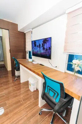an office with a desk and two chairs at Boutique Air Retreat Relax Laugh Swim Gym Car Park 1767 in Manila
