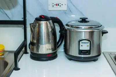 a tea pot and kettle sitting on top of a stove at Boutique Air Retreat Relax Laugh Swim Gym Car Park 1767 in Manila