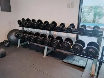 a rack filled with lots of dumbbells in a room at Casa Makati in Manila