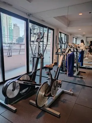 a gym with several exercise bikes in a room at Casa Makati in Manila