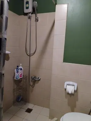 a bathroom with a shower stall with a toilet at Casa Makati in Manila