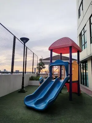 a playground in a building with a slide at Casa Makati in Manila