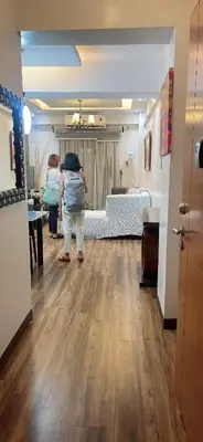 a woman standing in a room with a bedroom at Resorts world condotel High speed wifi in Manila