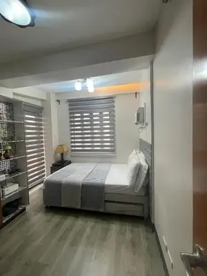 a bedroom with a large bed and a window at Resorts world condotel High speed wifi in Manila