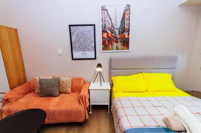 a bedroom with two beds and a bedskirts at The Laughing Loft Cosmopolitan Comfort Gym Swim Park 2428 in Manila