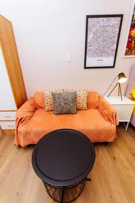 a living room with a couch and a table at The Laughing Loft Cosmopolitan Comfort Gym Swim Park 2428 in Manila