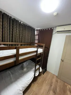 two bunk beds in a room with a window at The Serenity Tower 2706 in Manila