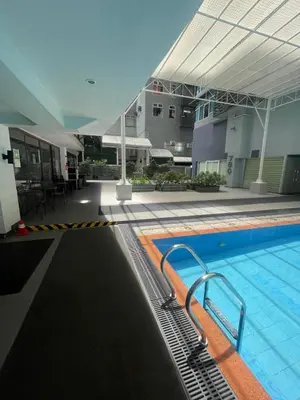 a large swimming pool in a building with a building at The Serenity Tower 2706 in Manila