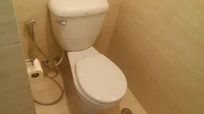 a bathroom with a toilet and a shower at Jerry's Homestay in Manila