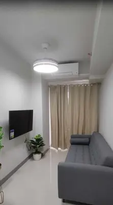 a living room with a couch and a flat screen tv at Happy Home Haven At S Residences Moa in Manila