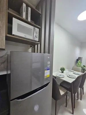 a small kitchen with a table and a microwave at Happy Home Haven At S Residences Moa in Manila