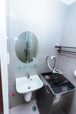 a small bathroom with a sink and a mirror at Serene City Stay Trendy Cozy Makati Condo Fun Swim Gym Netflix 4047 in Manila