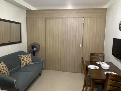 a living room with a couch and a table at ren&ayesha place in Manila