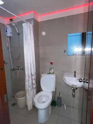 a bathroom with a toilet and a sink at Kaireese Properties in Manila