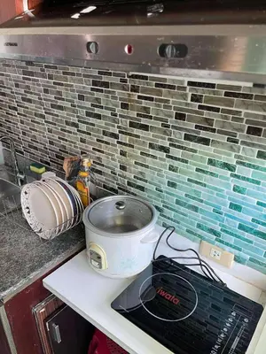 a kitchen counter with a stove and a pot on it at Kaireese Properties in Manila