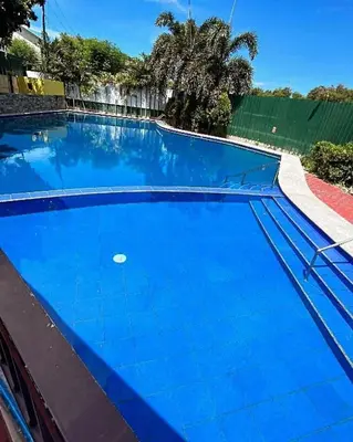 a large swimming pool with blue water at Kaireese Properties in Manila