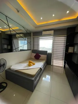 a bedroom with a bed in a room at Mall of asia fireworks view from balcony 15floor in Manila