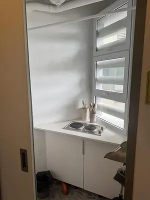 a white kitchen with a sink and a window at Greenhills shopping center 2BR condominium in Manila