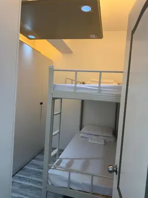 a bunk bed in a small room with a ladder at Greenhills shopping center 2BR condominium in Manila