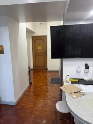 a room with a large flat screen tv on a wall at Greenhills shopping center studio condominium in Manila