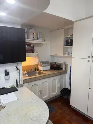 a kitchen with white cabinets and a counter top at Greenhills shopping center studio condominium in Manila