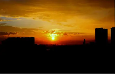a sunset over a city with buildings in the foreground at 2BR Condotel Ridgewood Tower Taguig in Manila