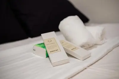 two boxes of soap and a towel on a bed at Shore residences tower D Staycation near Sm moa in Manila