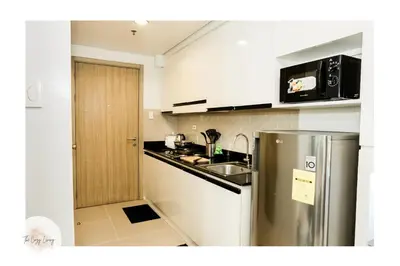 a kitchen with a stainless steel refrigerator and a sink at Shore residences tower D Staycation near Sm moa in Manila