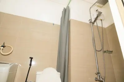 a bathroom with a shower with a toilet and a shower curtain at Shore residences tower D Staycation near Sm moa in Manila