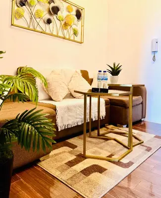 a living room with a couch and a table at The Air Residences #3724 in Manila