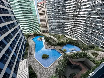 an overhead view of a pool in a city with tall buildings at The Air Residences #3724 in Manila
