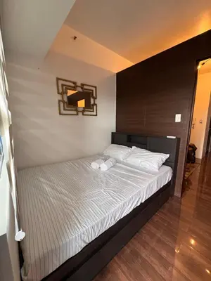 a bedroom with a large bed with white sheets at The Air Residences #3724 in Manila