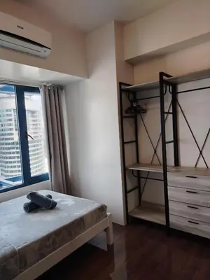 a bedroom with two bunk beds and a window at Cozy & Stylish Staycation and Netflix - WiFi and Pool in Manila
