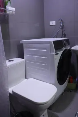 a white toilet with a computer on top of it at Cozy & Stylish Staycation and Netflix - WiFi and Pool in Manila