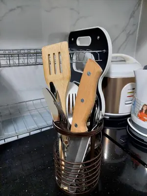 a basket filled with utensils on a kitchen counter at Solemare Parksuites in Manila