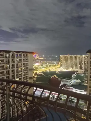 a view of a city at night from a balcony at Solemare Parksuites in Manila