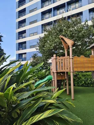 a playground in front of a tall building at Air Residences by Christine Suites PH Makati City in Manila