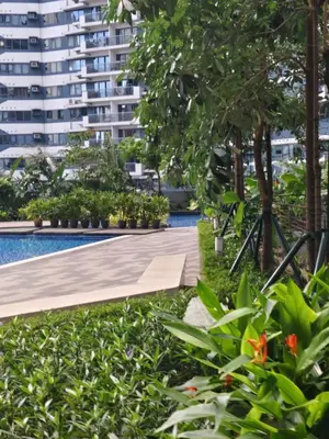 a walkway in front of a large building at Air Residences by Christine Suites PH Makati City in Manila