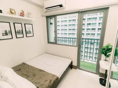 a white room with a bed and a window at 5-Star Feel and Step in Luxury at Fame Residences in Manila