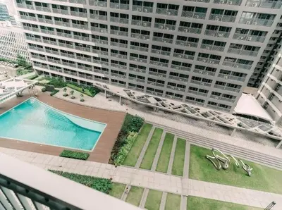 an aerial view of a large building with a swimming pool at 5-Star Feel and Step in Luxury at Fame Residences in Manila
