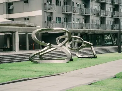 a large metal sculpture in front of a building at 5-Star Feel and Step in Luxury at Fame Residences in Manila