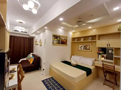 a small room with a bed and a desk at S Residences 942b near airport pasay in Manila